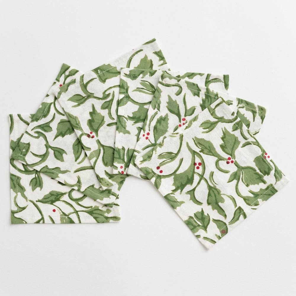 Cocktail napkins with holly berries on white background
