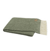 Folded green blanket with white fringe on a white background