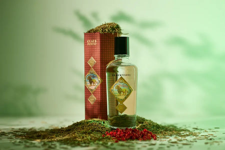 Bottle and box with a decorative design on a green background