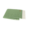 Green blanket with white fringe on a white background