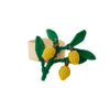 Woven napkin ring with green leaves and yellow fruits on a white background