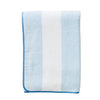 Folded blue and white towel on a white   background