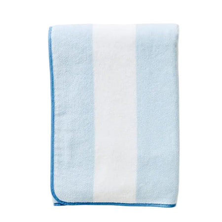 Folded blue and white towel on a white   background