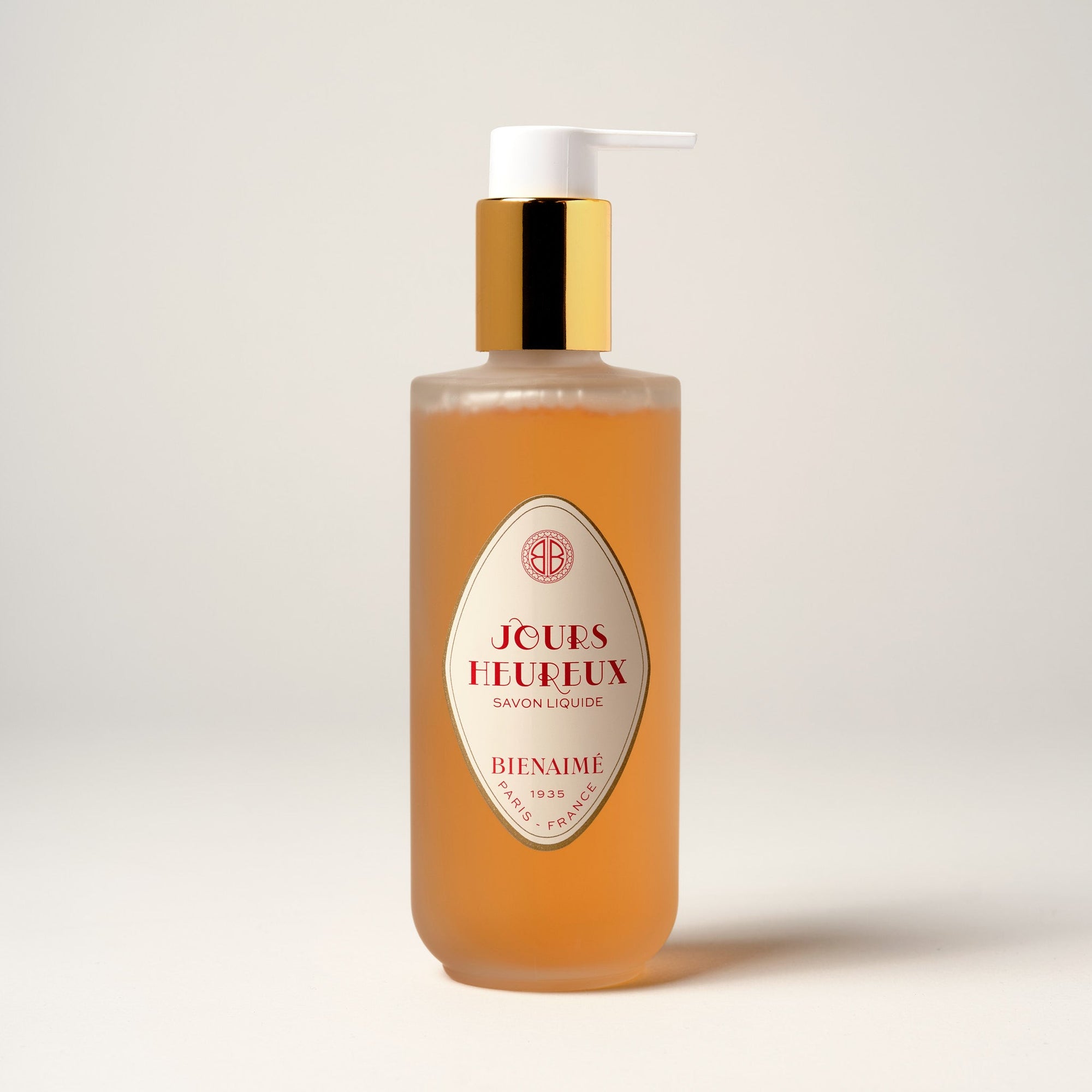 Liquid soap bottle with a label on a plain background