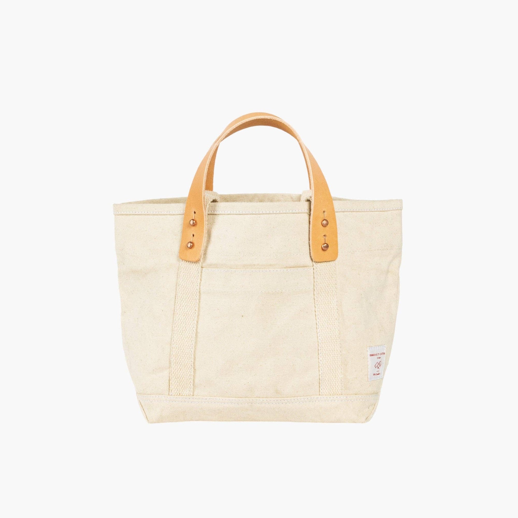 Natural lunch tote with leather handles on white background 