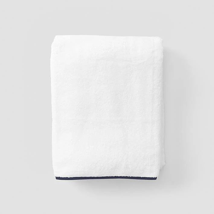 Towel with navy piping on grey background
