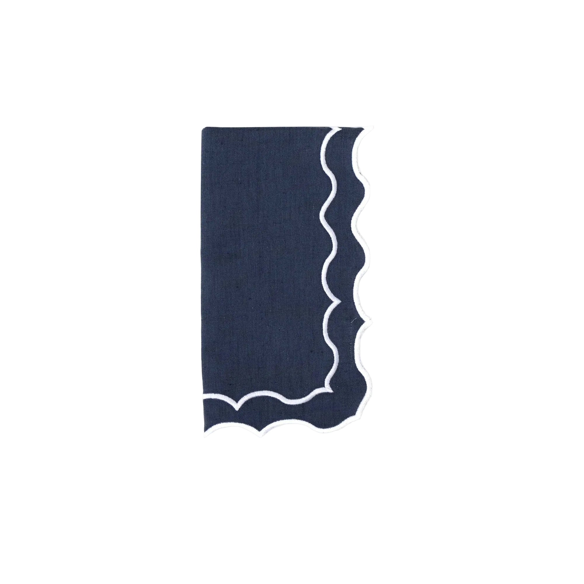 Navy blue napkin with wavy white border on a white background