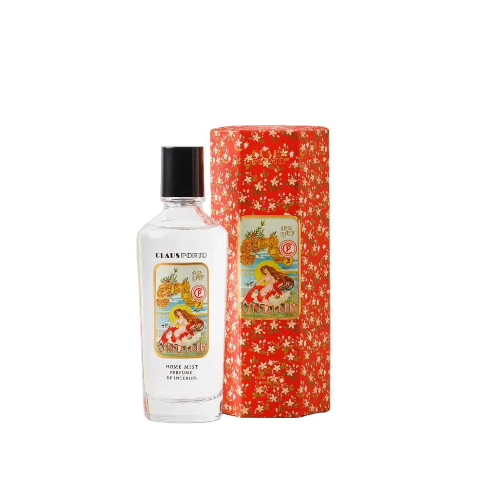 Perfume bottle with decorative packaging on a light gray background