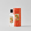 Perfume bottle with decorative packaging on a light gray background