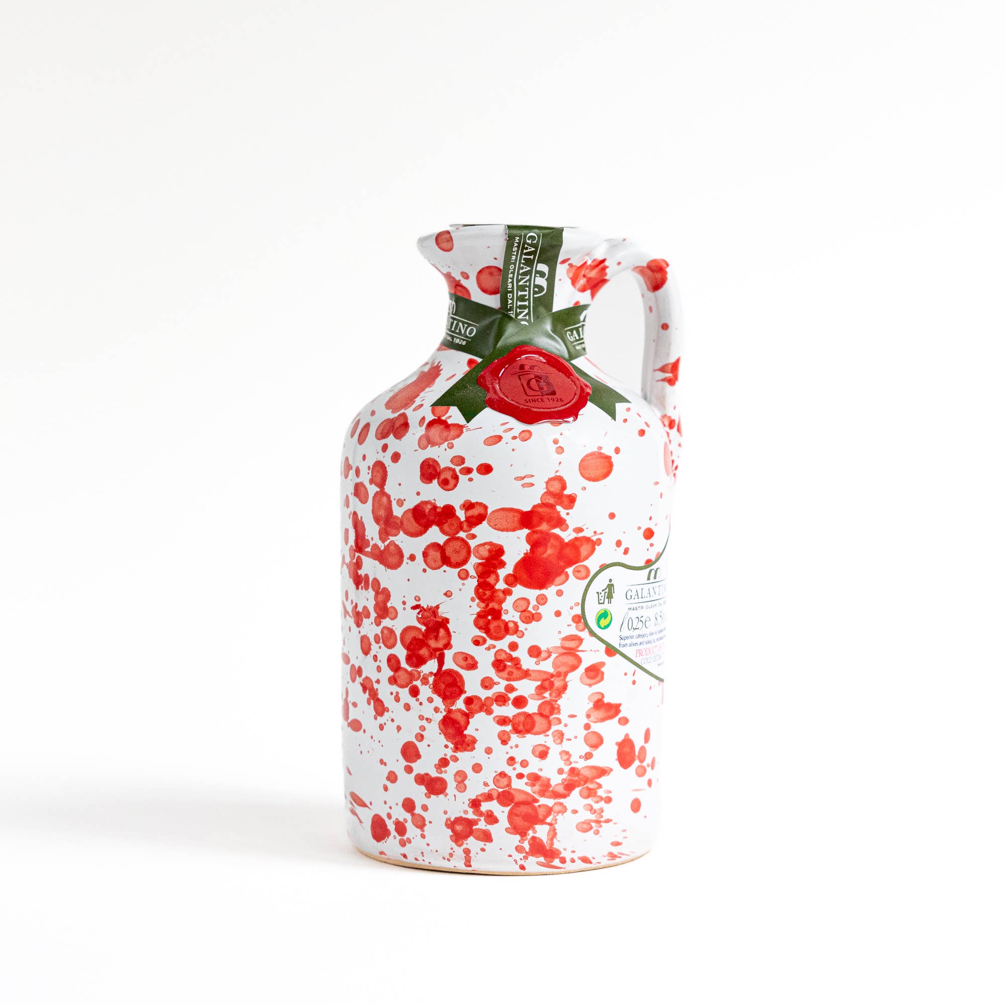 Red splatter ceramic bottle of extra virgin olive oil on white background 