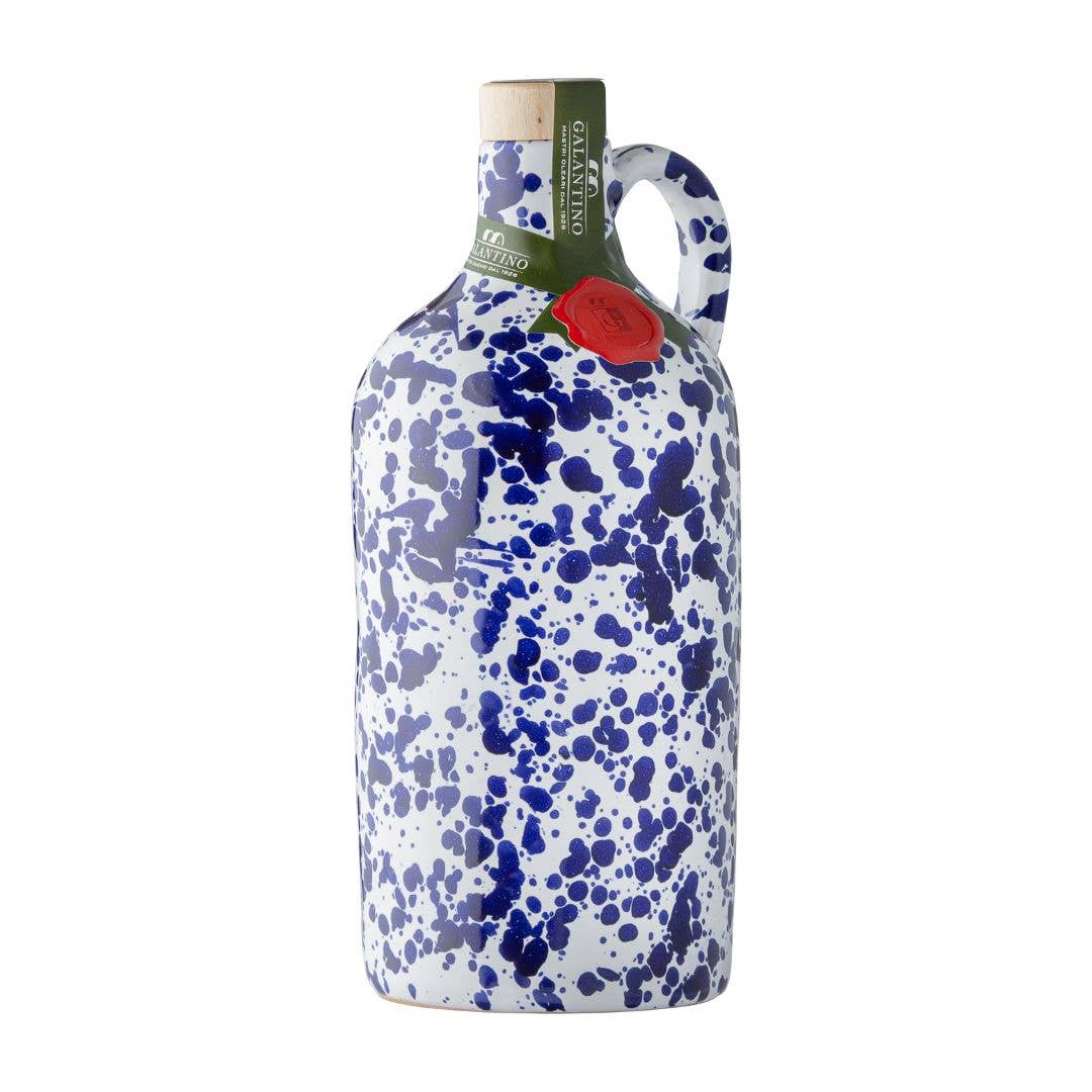 Cobalt splatter ceramic bottle of extra virgin olive oil with cork top on white background 