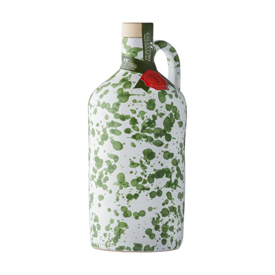 Green splatter ceramic bottle of extra virgin olive oil with cork top on white background 