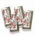 Four folded cotton napkins with a traditional block-print style design featuring green birds, pink pomegranates, and dark green borders on an off-white background.
