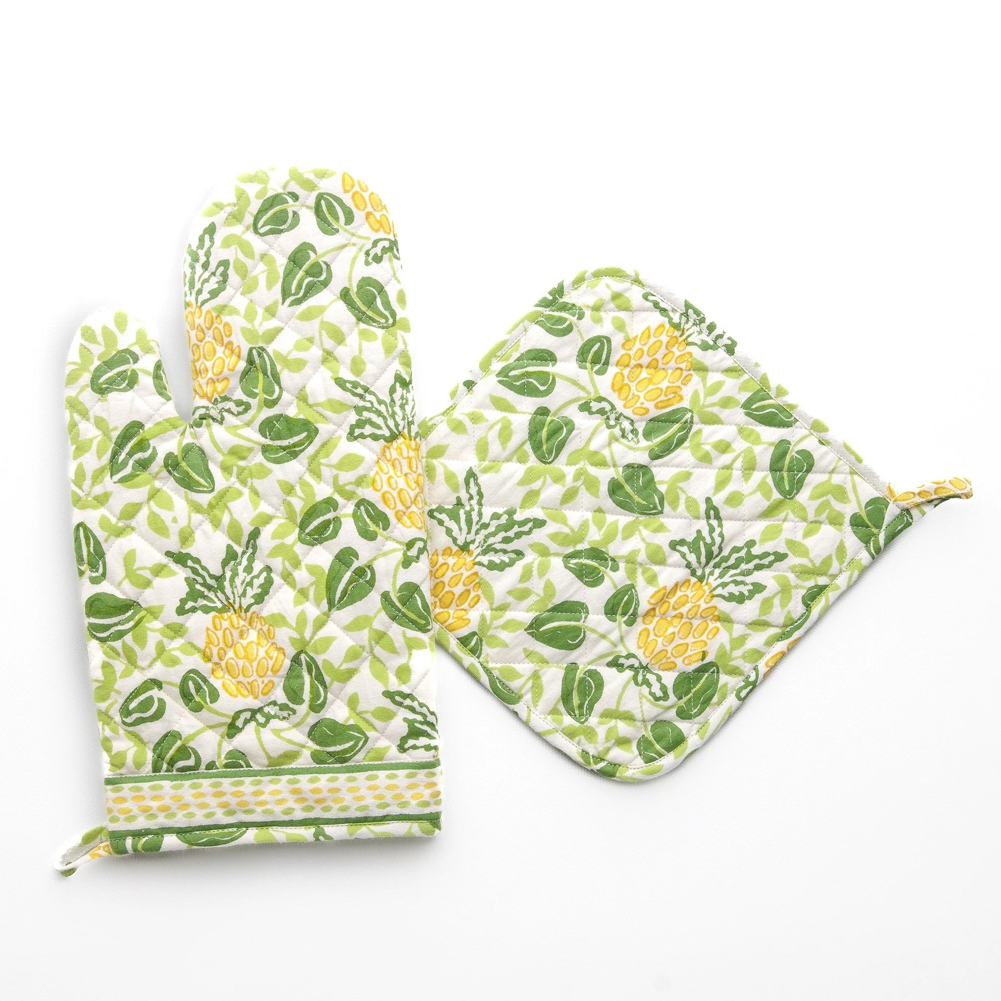 Set of oven mitt and pot holder with pineapple and leaf pattern on a white background