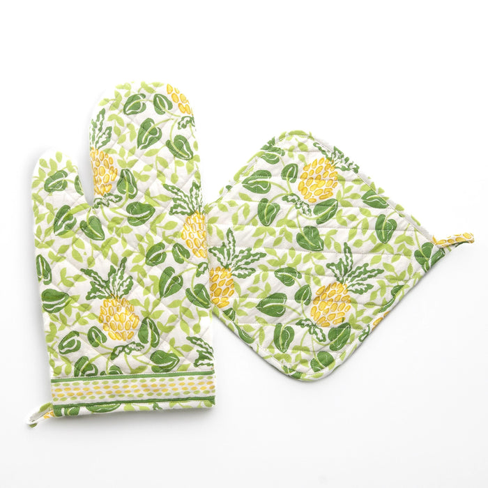 Set of oven mitt and pot holder with pineapple and leaf pattern on a white background