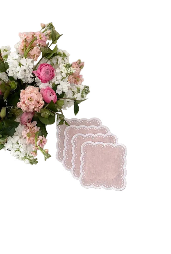 Pink scalloped coasters on a white background