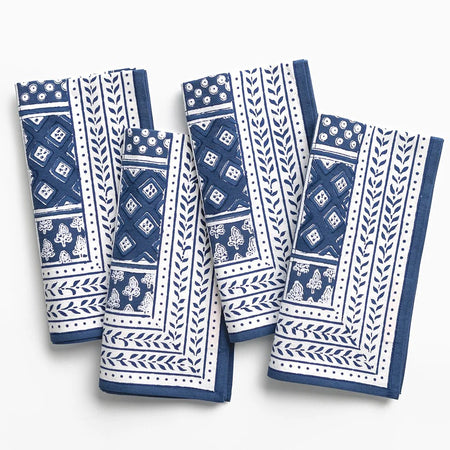 Set of blue and white patterned napkins on a white background