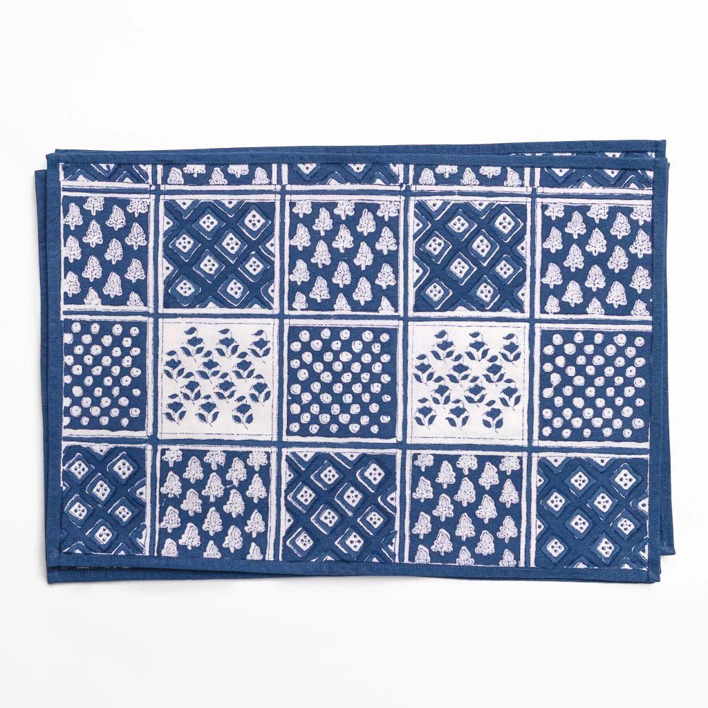 Blue and white patterned fabric with a grid of various designs on a white background