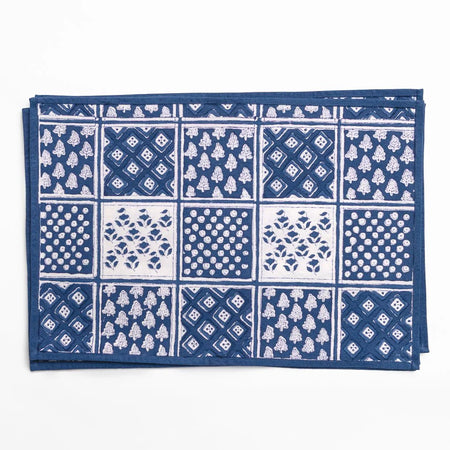 Blue and white patterned fabric with a grid of various designs on a white background