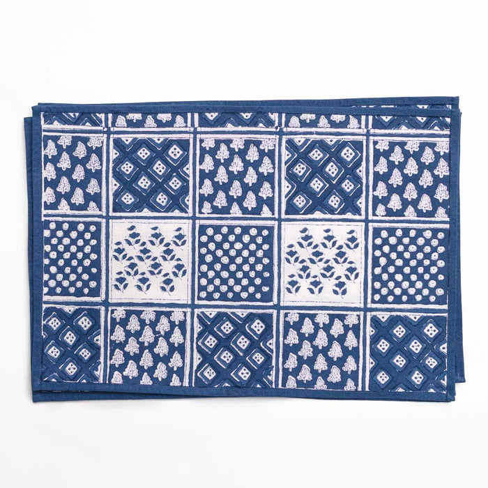 Blue and white patterned fabric with a grid of various designs on a white background