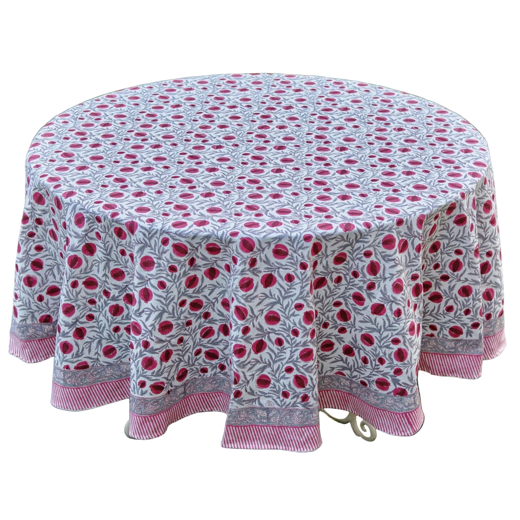 Round tablecloth with pink floral pattern on grass