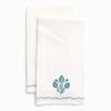 Two white towels with blue floral designs on a white background