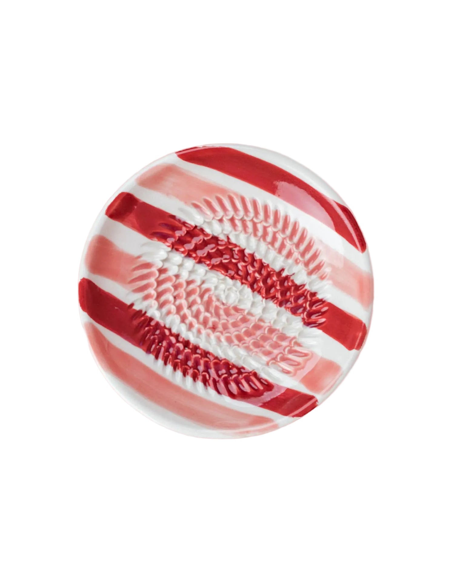 Decorative plate with red and white pattern on a pink background