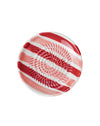 Decorative plate with red and white pattern on a pink background