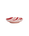 Decorative plate with red and white pattern on a pink background