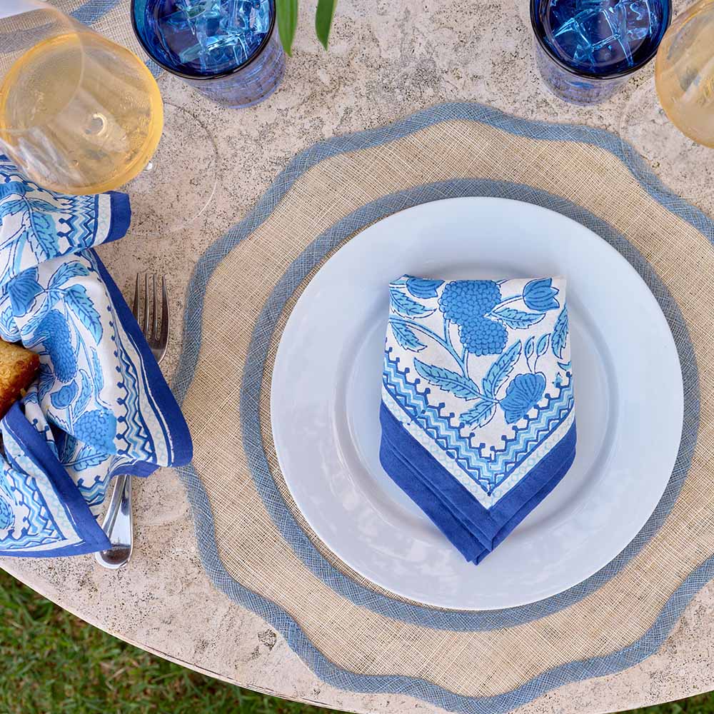 Placemats of natural fiber with scalloped edge on table