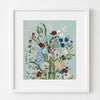Framed floral artwork on a light blue background