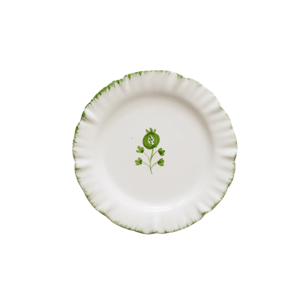 White plate with green floral design on a white background
