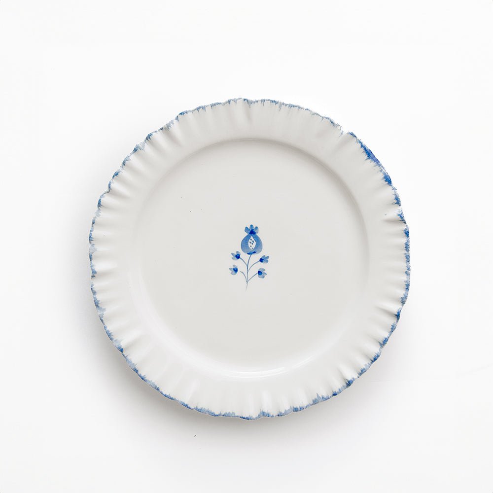 White ceramic plate with blue floral design on a white background
