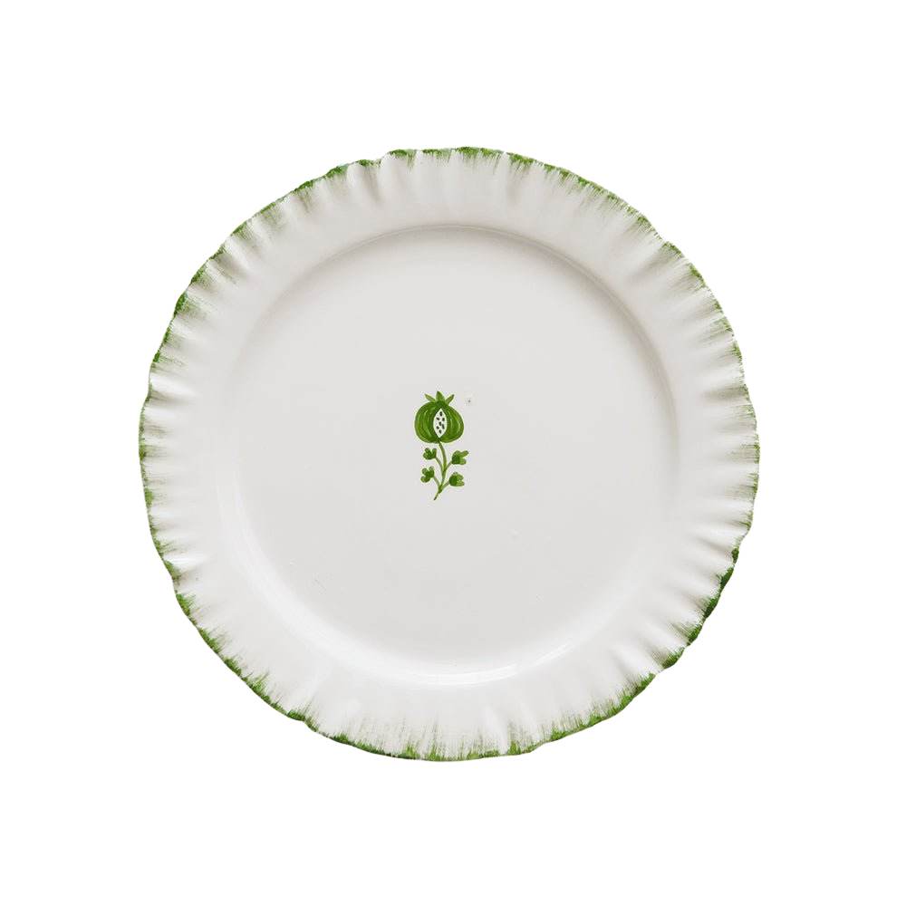 White plate with green rim and floral design on a white background