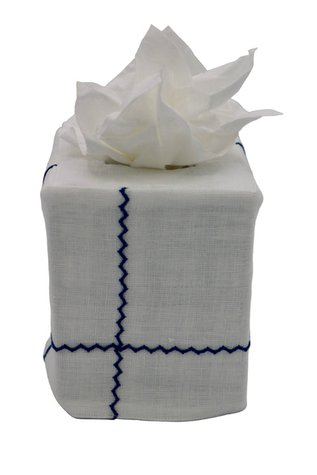 Tissue box cover with white tissue on a gray background