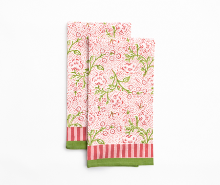Set of two floral patterned napkins with green and red accents on a white background