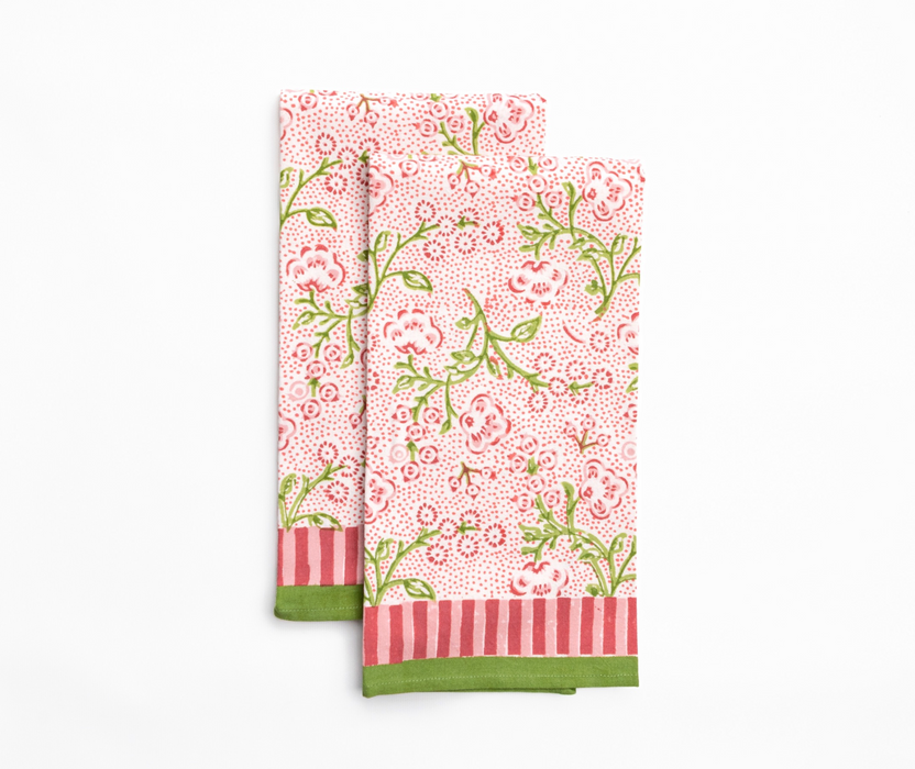 Set of two floral patterned napkins with green and red accents on a white background