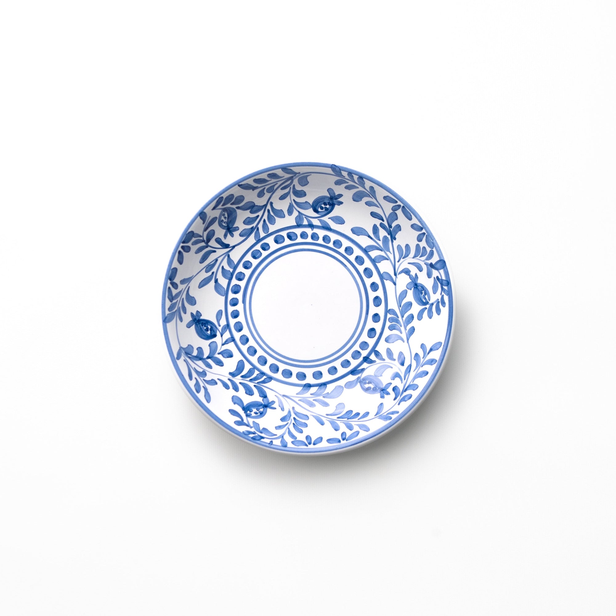 Pasta bowl with blue scroll detail on white background. 