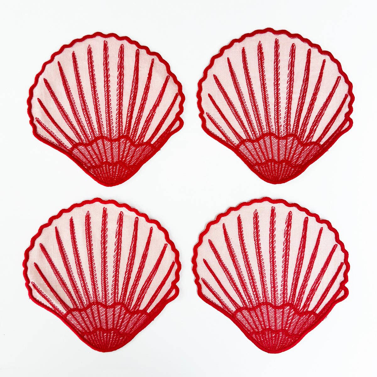 Set of 4 red seashell cocktail napkins on white background