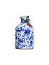 Small cobalt splatter ceramic bottle of olive oil with cork top on white background 