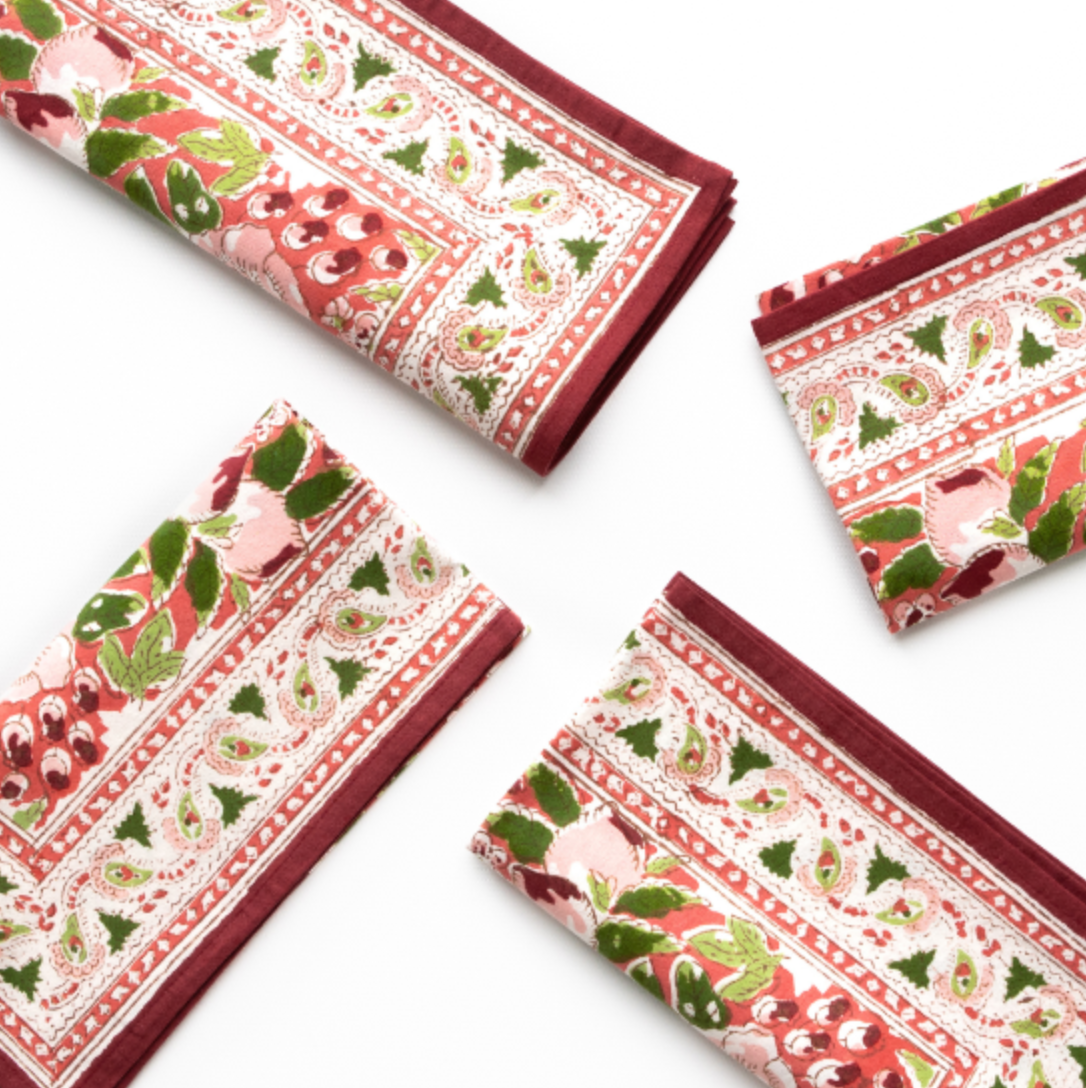 Rich red, green and coral hues napkins on white background 