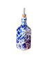 Blue and white splatter olive oil dispenser with cork top on white background 