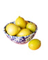 Blue and white splatter serving bowl with lemons on white background 