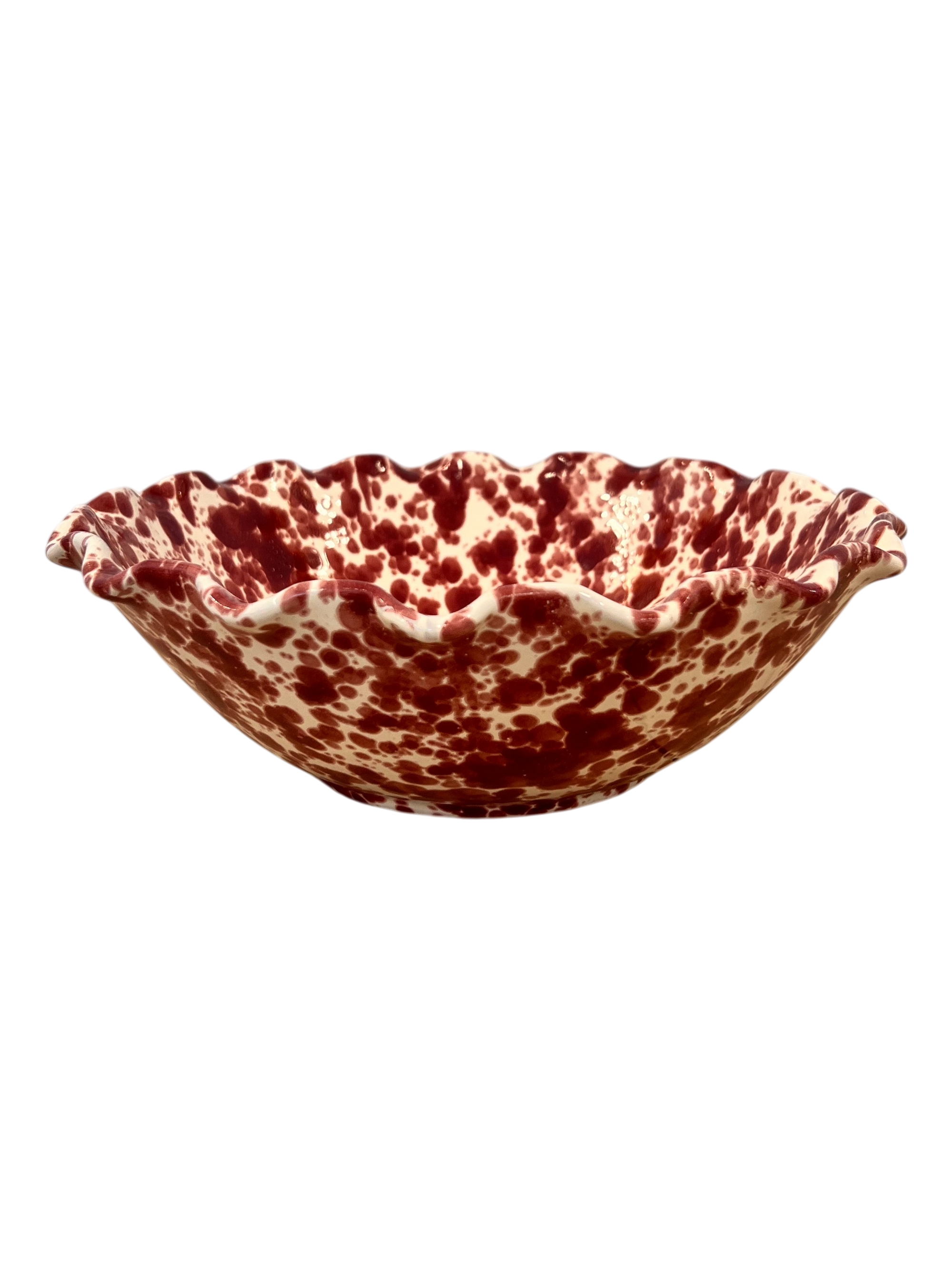 A ceramic bowl with a scalloped rim, featuring a marbled pattern of deep red and cream glaze, isolated on a white background.