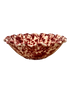A ceramic bowl with a scalloped rim, featuring a marbled pattern of deep red and cream glaze, isolated on a white background.