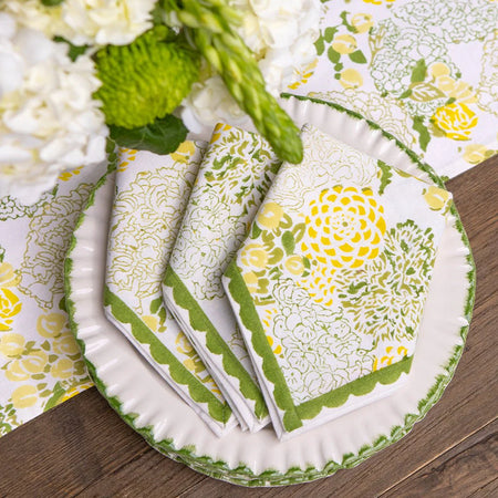 Set of floral-patterned plates and napkins on a wooden surface