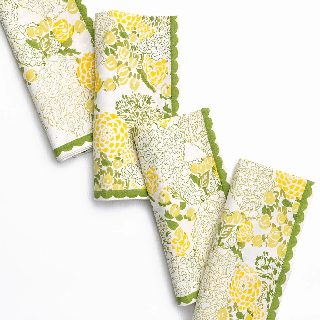 Set of four floral-patterned napkins with green accents on a white background