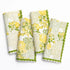 Four floral patterned towels with green accents on a white background