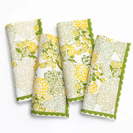 Four floral patterned towels with green accents on a white background