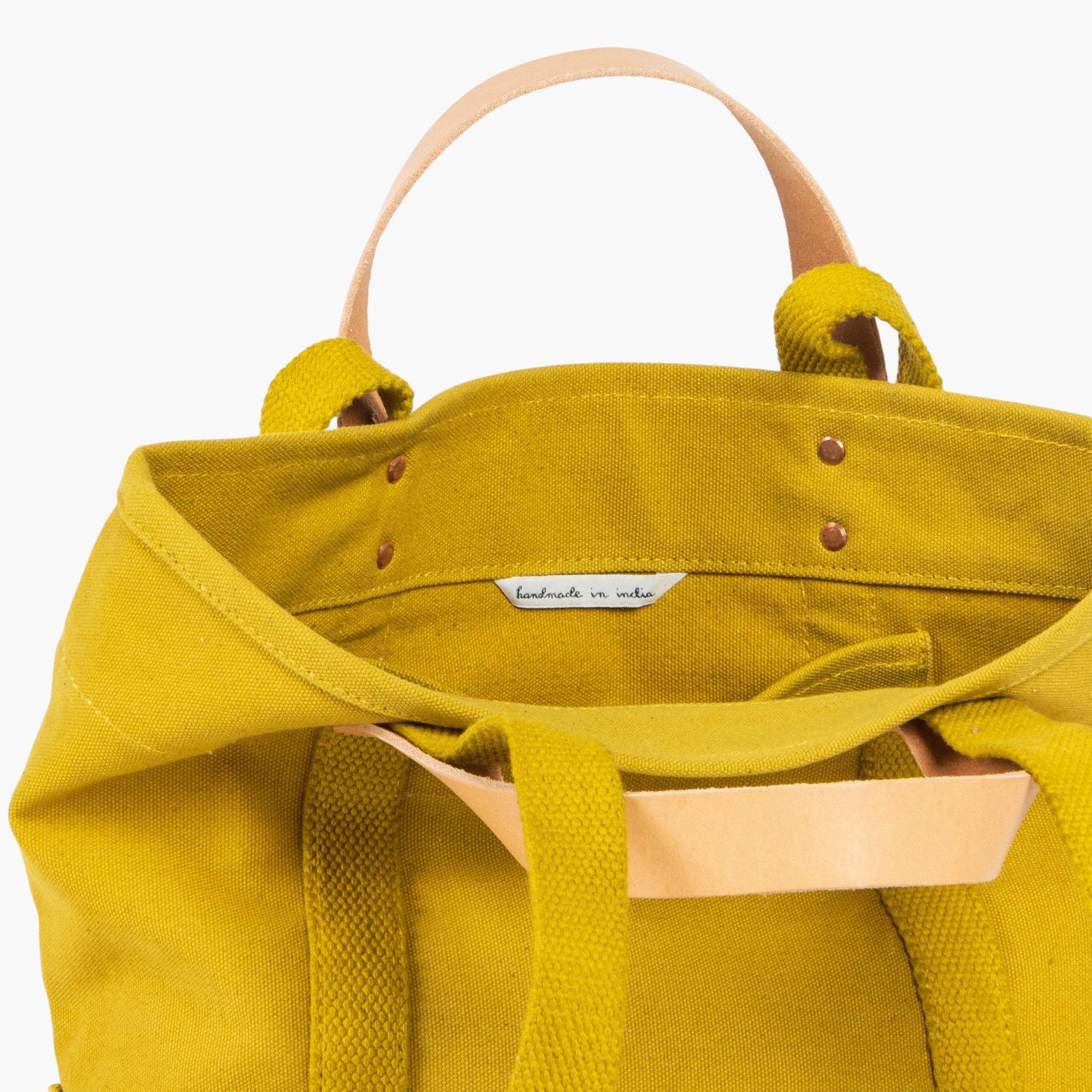 Lunch tote in chartruese with inside pocket and leather handles and canvas shoulder strap on white background 